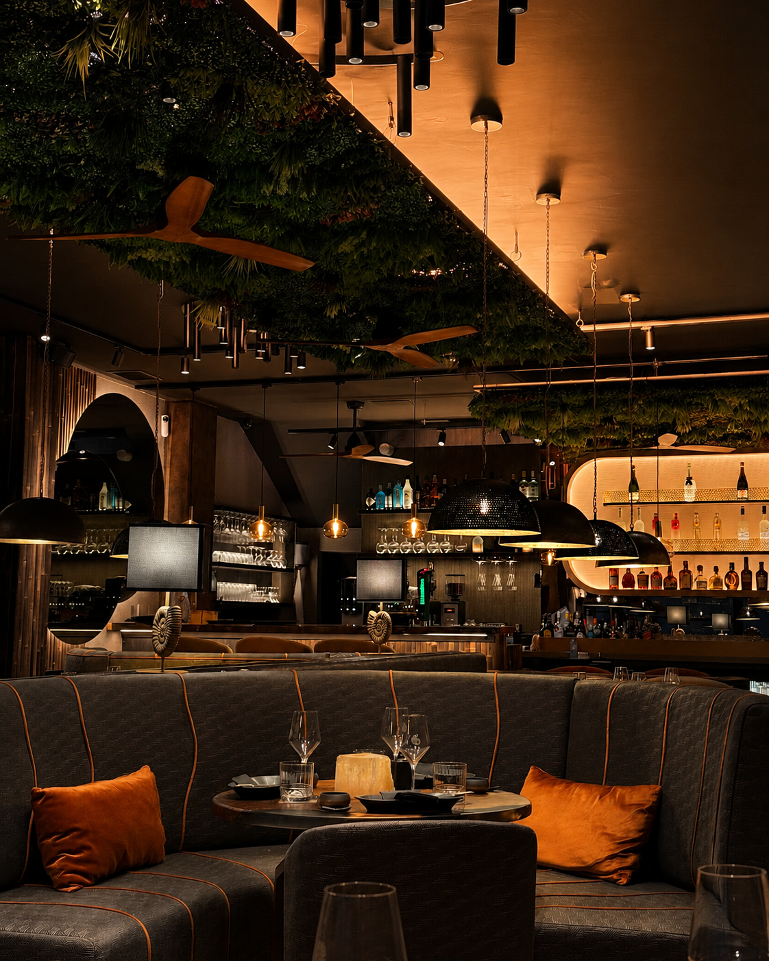 Marije Richards hospitality interior — warm ambient lounge with banquette seating and pendant lighting